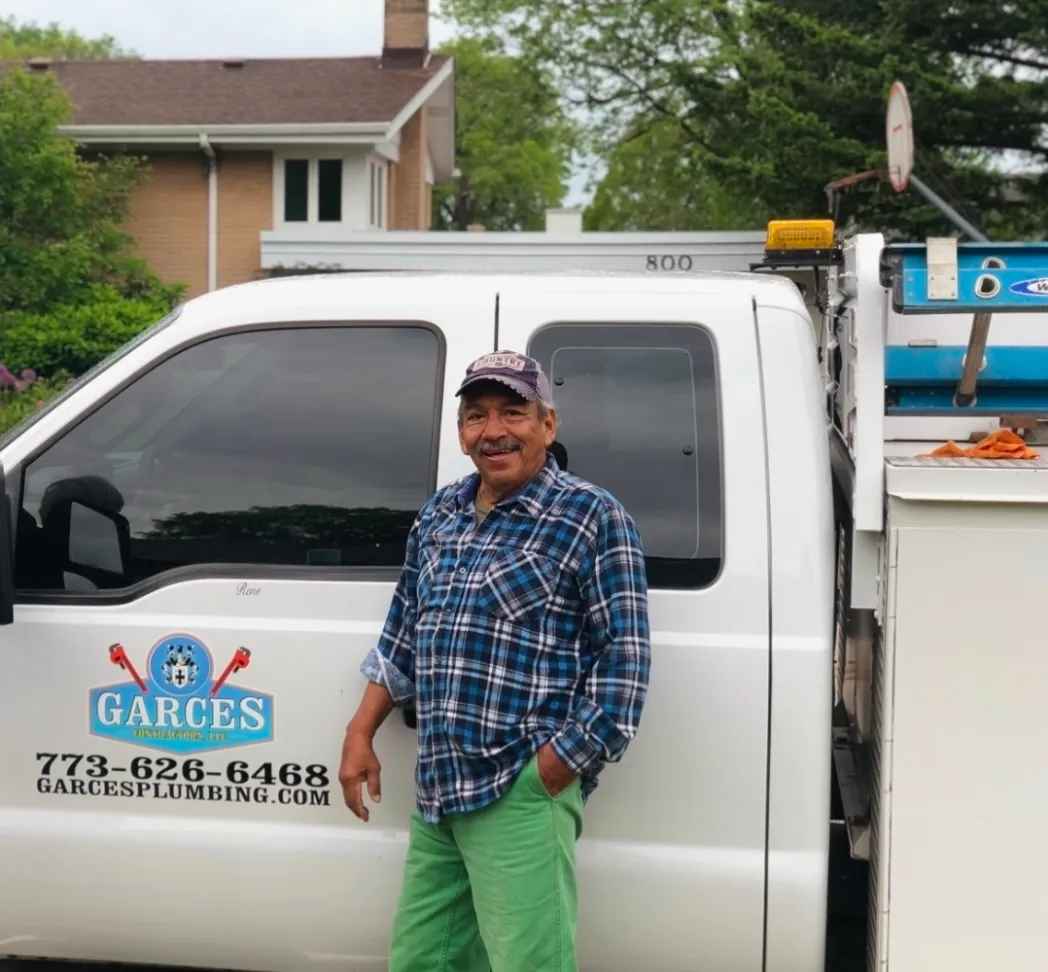Company founder standing beside a service truck