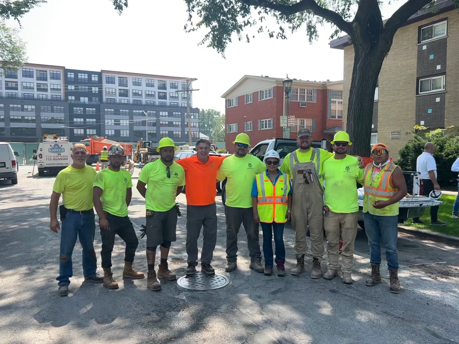 Company plumbing crew gathered at a job site